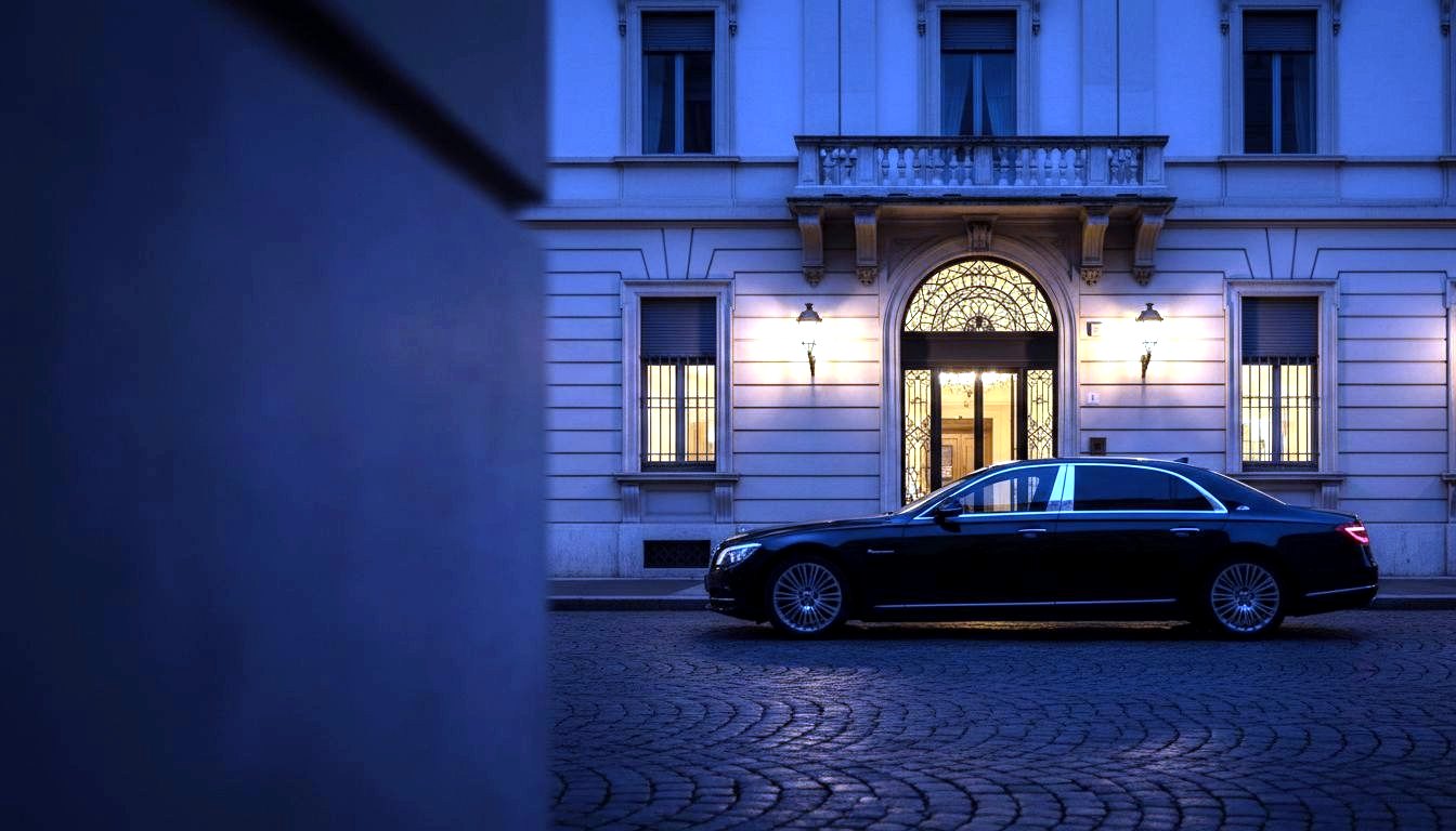 Executive saloon in front of an elegant Milan building at blue hour