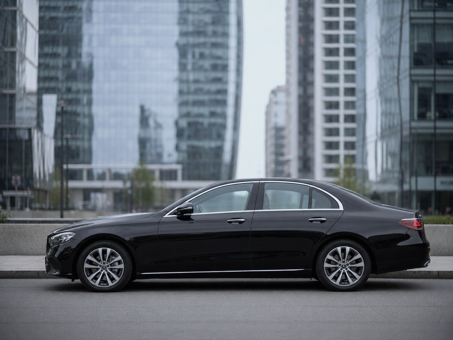 Executive sedan parked and waiting in a Milan business district during the day